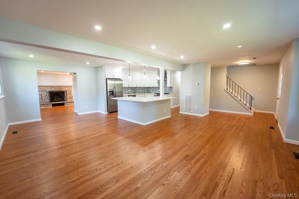 Empty room, Interior, Kitchen, Pendant Lights, Recessed Lighting, Stainless Steel Appliances, Wood Texture Flooring