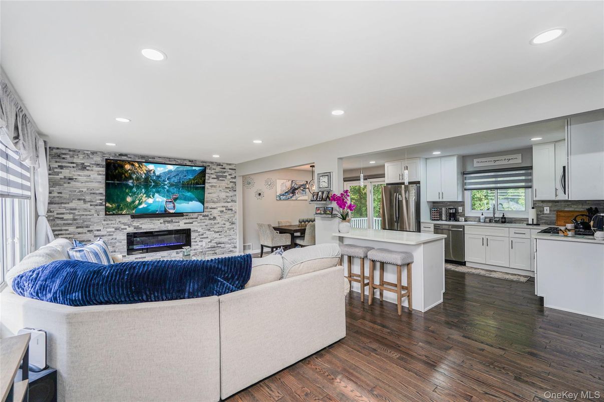 Fireplace, Interior, Kitchen, Living room, Recessed Lighting, Stainless Steel Appliances, Stone Walls, Wood Texture Flooring