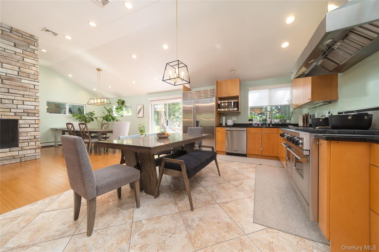 Dining room, Fireplace, Interior, Kitchen, Pendant Lights, Recessed Lighting, Stainless Steel Appliances, Stone Walls, Wood Texture Flooring