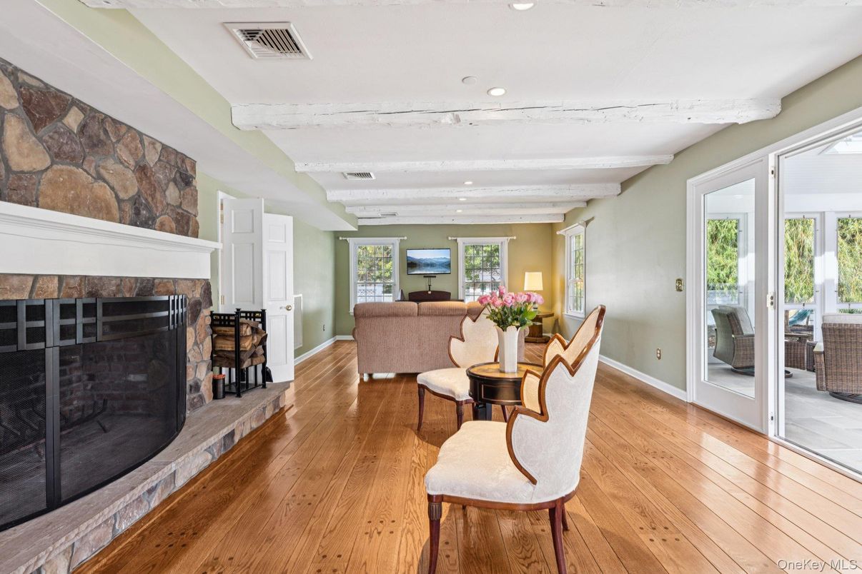 Dining room, Fireplace, Interior, Living room, Recessed Lighting, Stone Walls, Wood Texture Flooring