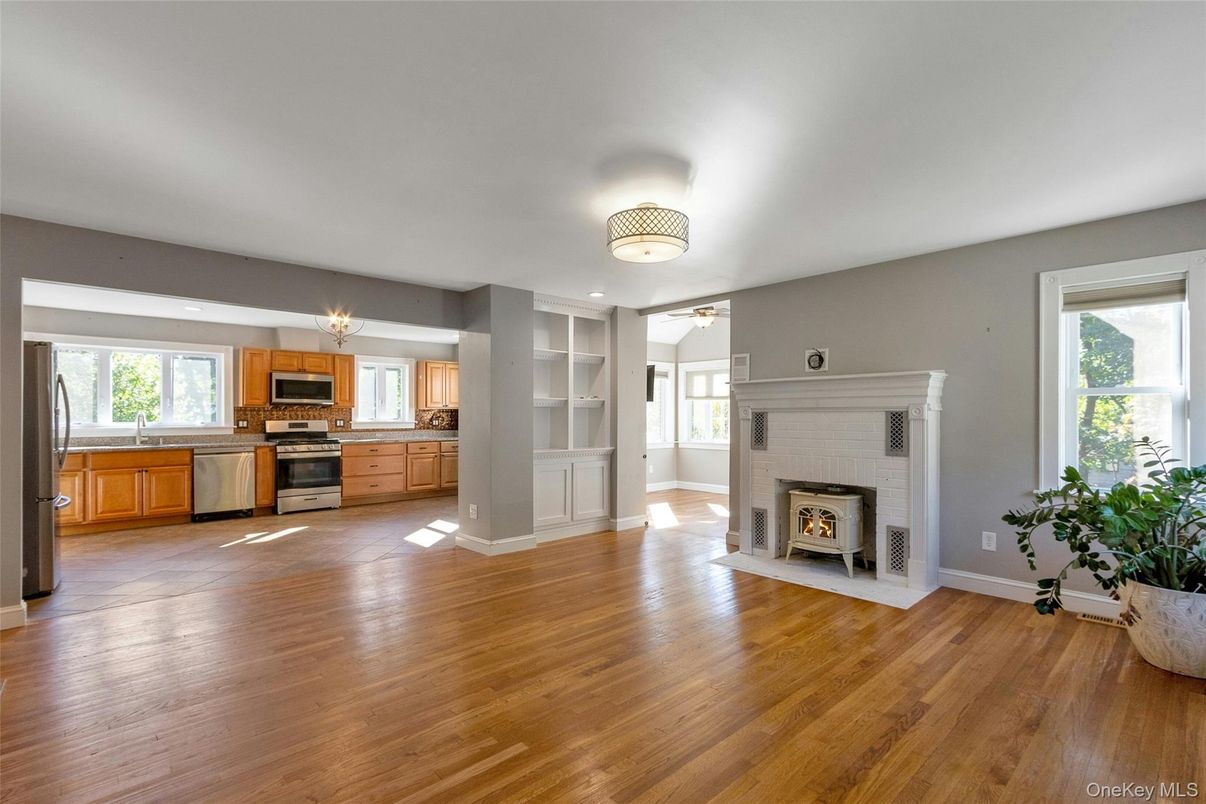 Empty room, Fireplace, Interior, Kitchen, Stainless Steel Appliances, Wood Texture Flooring