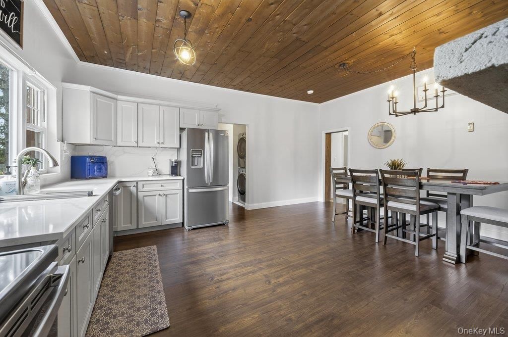 Chandelier, Dining room, Interior, Kitchen, Recessed Lighting, Stainless Steel Appliances, Wooden Ceilings, Wood Texture Flooring