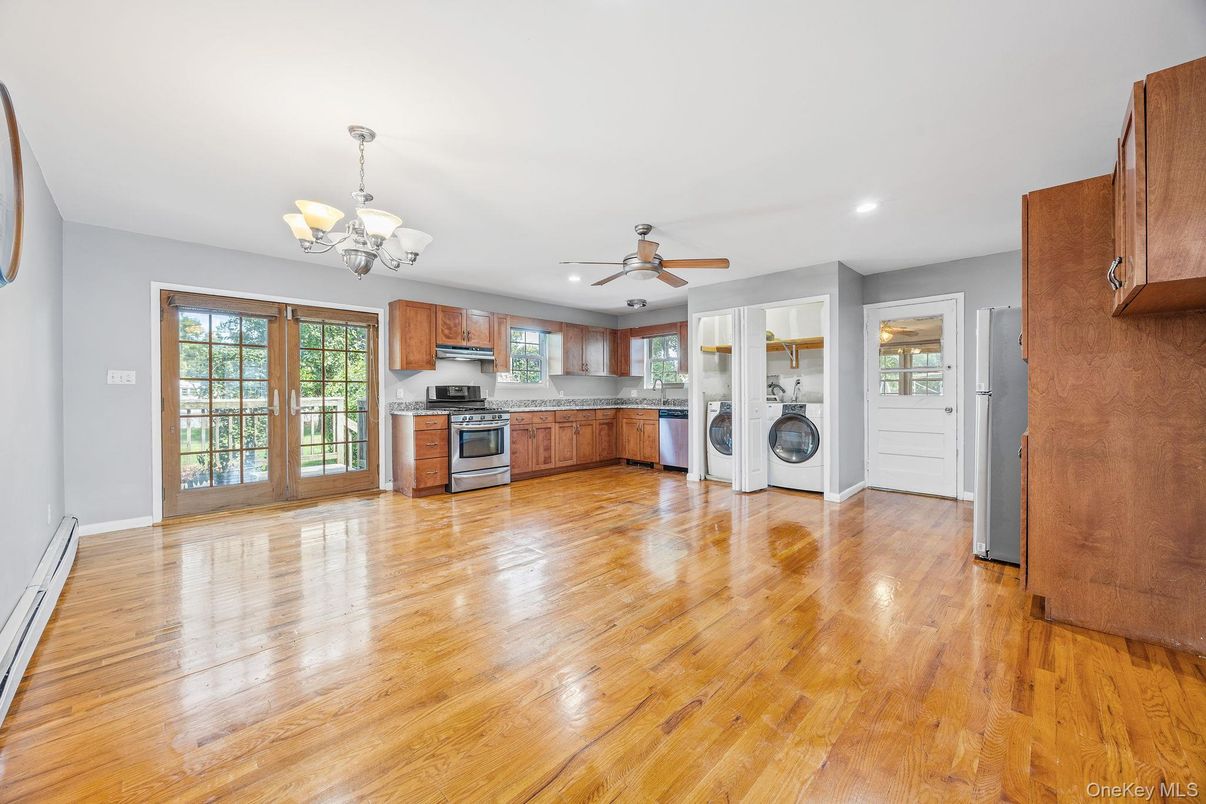 Chandelier, Empty room, Interior, Kitchen, Recessed Lighting, Stainless Steel Appliances, Washer, Wood Texture Flooring