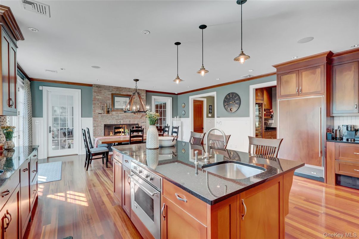 Dining room, Fireplace, Interior, Kitchen, Pendant Lights, Recessed Lighting, Stainless Steel Appliances, Stone Walls, Wood Texture Flooring