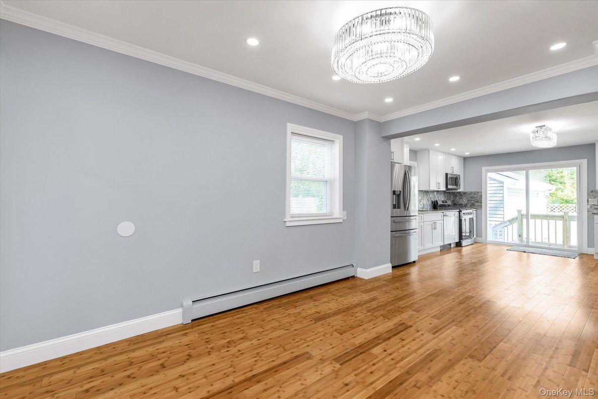 Chandelier, Empty room, Interior, Kitchen, Recessed Lighting, Stainless Steel Appliances, Wood Texture Flooring