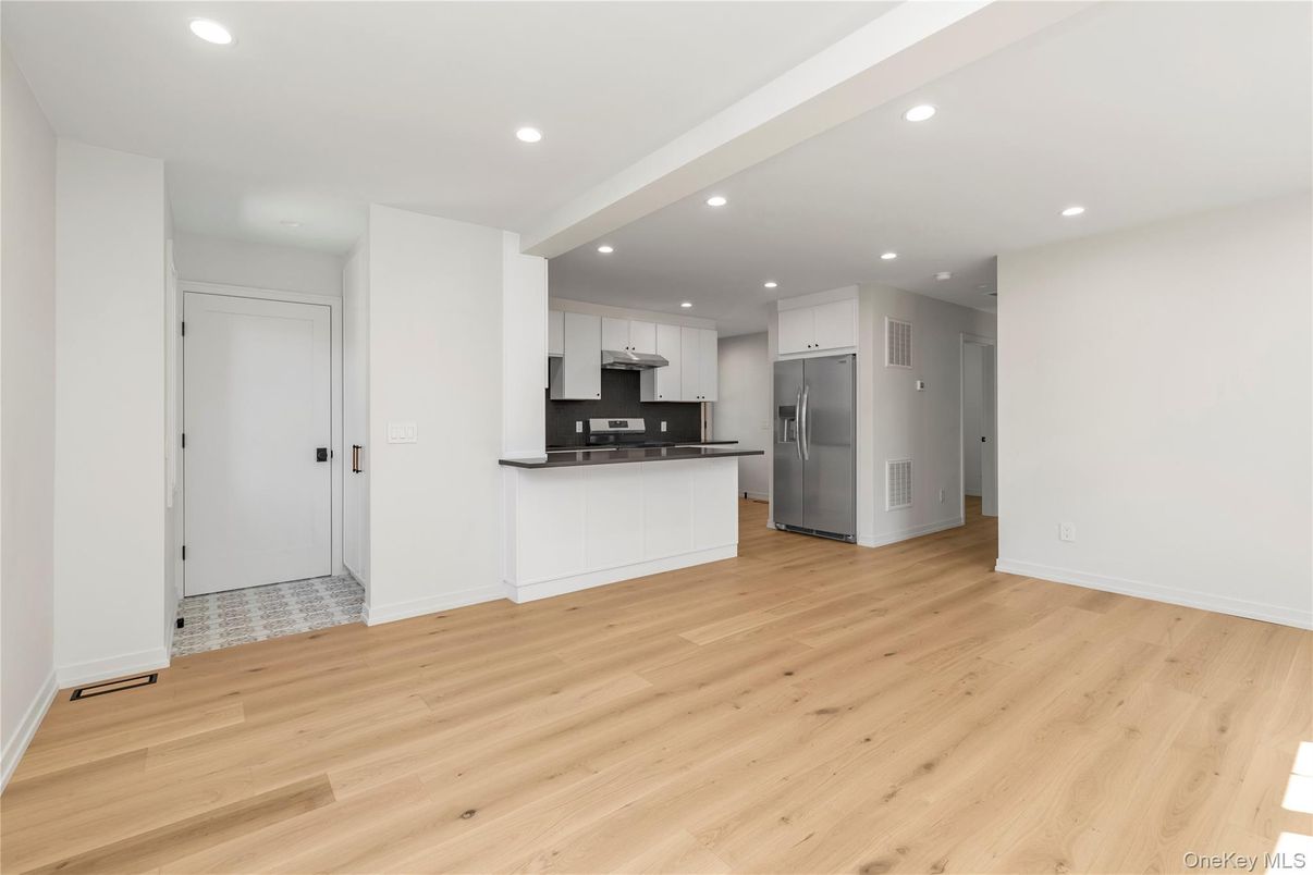 Empty room, Interior, Kitchen, Recessed Lighting, Stainless Steel Appliances, Wood Texture Flooring