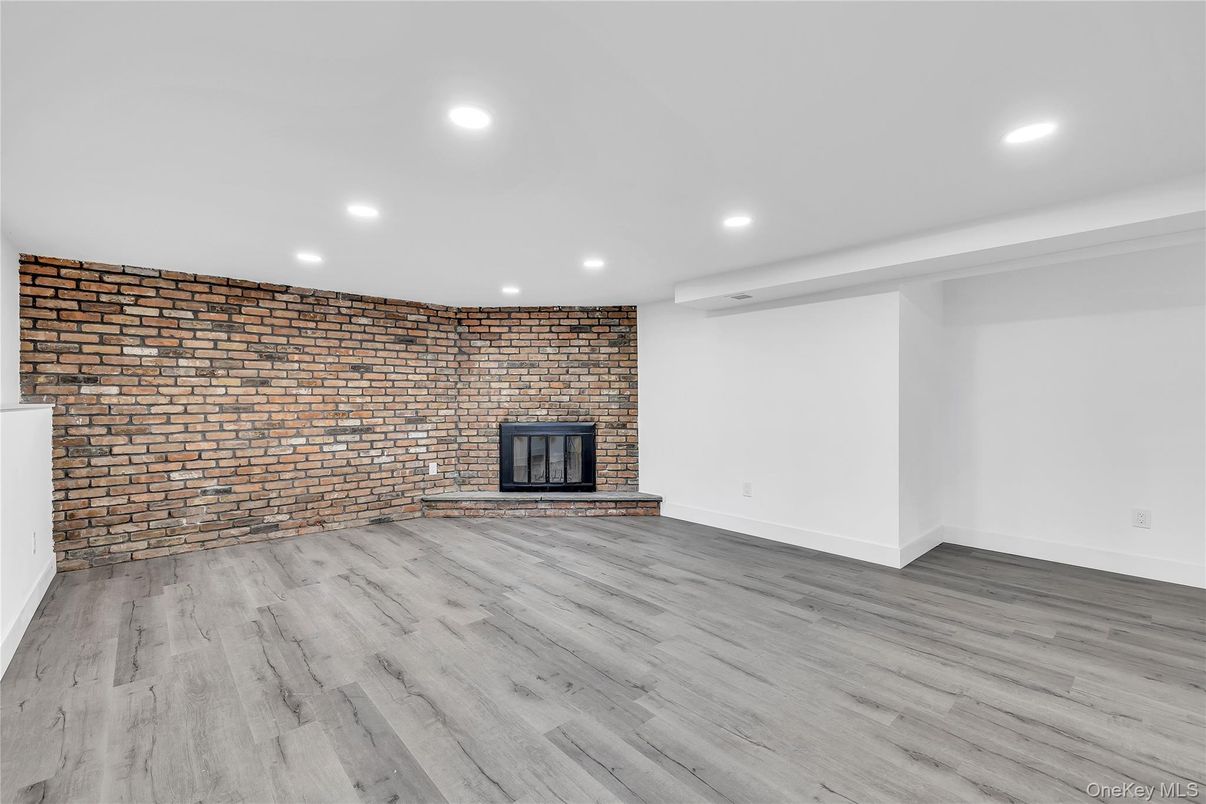 Empty room, Fireplace, Interior, Recessed Lighting, Stone Walls, Wood Texture Flooring