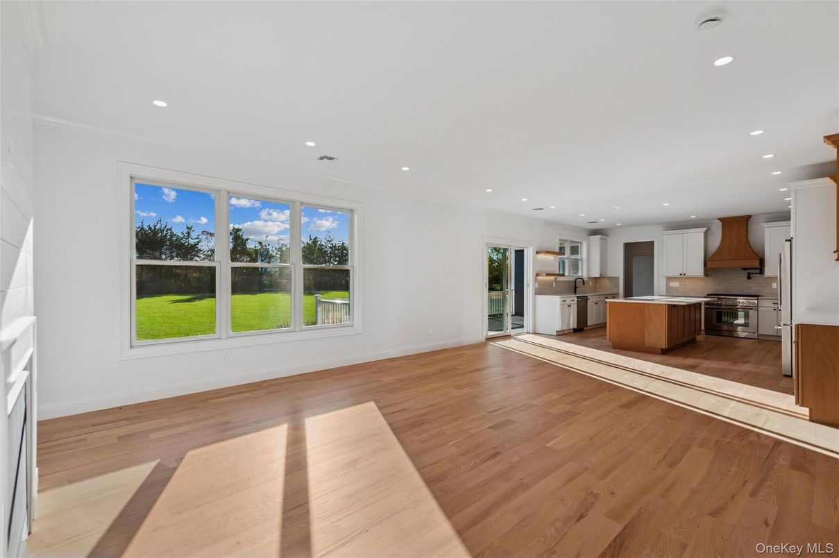 Empty room, Interior, Kitchen, Recessed Lighting, Stainless Steel Appliances, Wood Texture Flooring