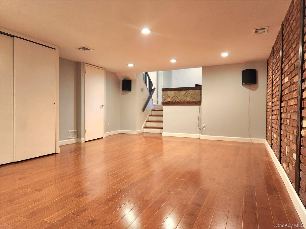Empty room, Fireplace, Interior, Recessed Lighting, Stone Walls, Wood Texture Flooring
