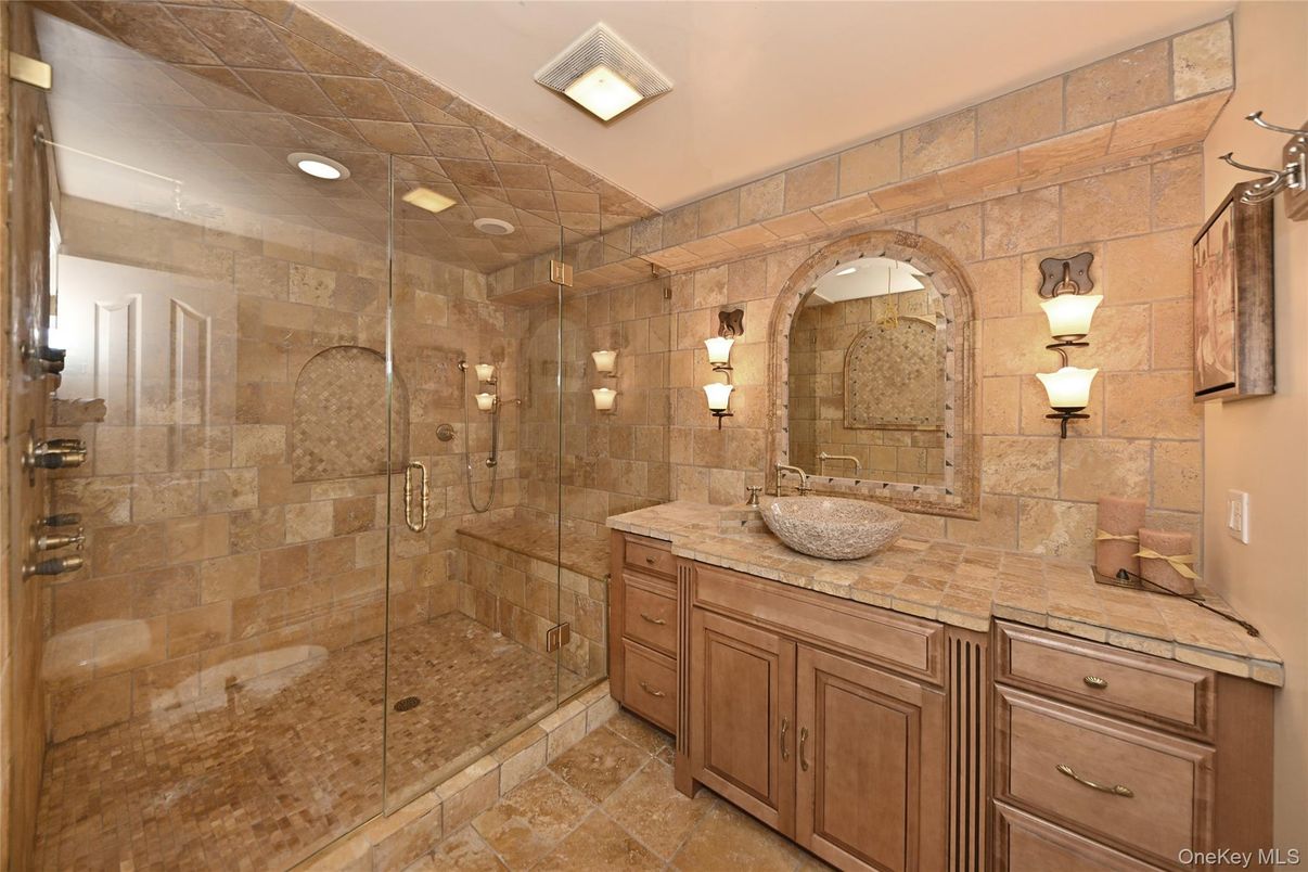 Bathroom, Dual Sink Vanities, Glass Shower, Interior, Recessed Lighting, Stone Walls, Tile Countertops