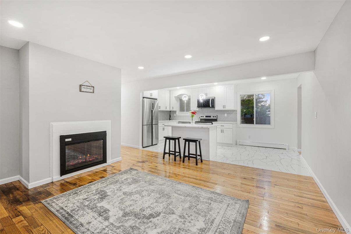 Fireplace, Interior, Kitchen, Marble, Pendant Lights, Recessed Lighting, Stainless Steel Appliances, Wood Texture Flooring