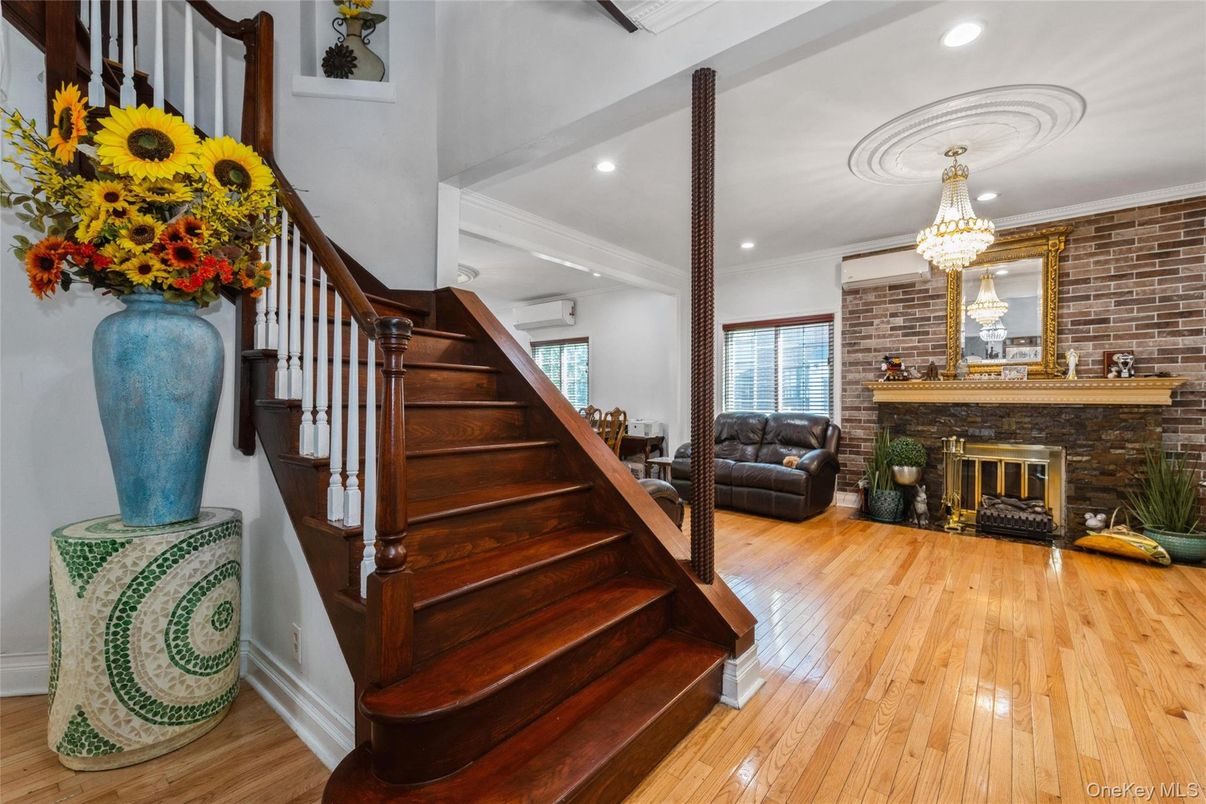 Chandelier, Fireplace, Interior, Recessed Lighting, Stone Walls, Wood Texture Flooring