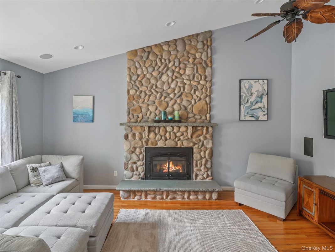 Fireplace, Interior, Living room, Recessed Lighting, Stone Walls, Wood Texture Flooring
