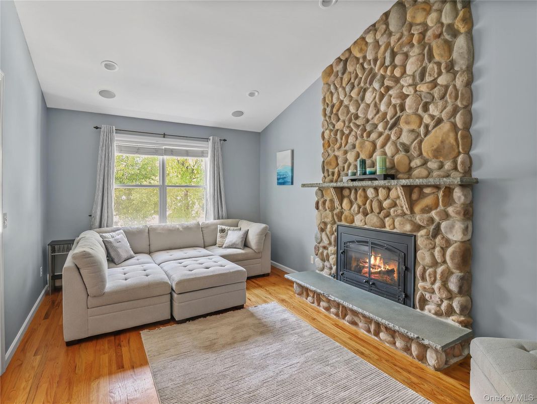 Fireplace, Interior, Living room, Recessed Lighting, Stone Walls, Wood Texture Flooring