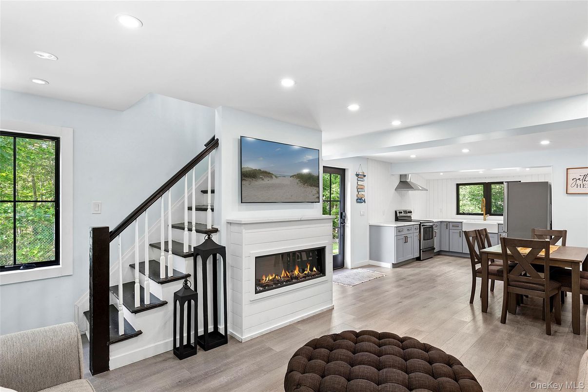 Dining room, Fireplace, Interior, Kitchen, Pendant Lights, Recessed Lighting, Stainless Steel Appliances, Wood Texture Flooring