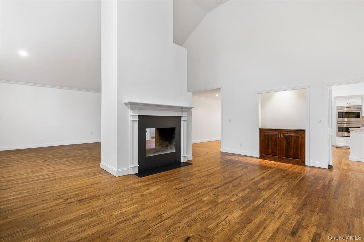 Empty room, Fireplace, Interior, Kitchen, Recessed Lighting, Wood Texture Flooring