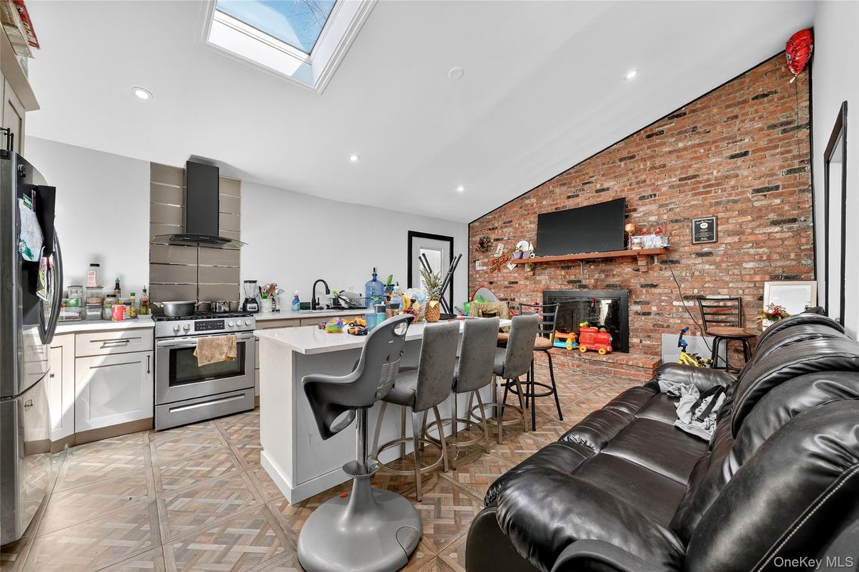 Fireplace, Interior, Kitchen, Living room, Recessed Lighting, Stainless Steel Appliances, Stone Walls