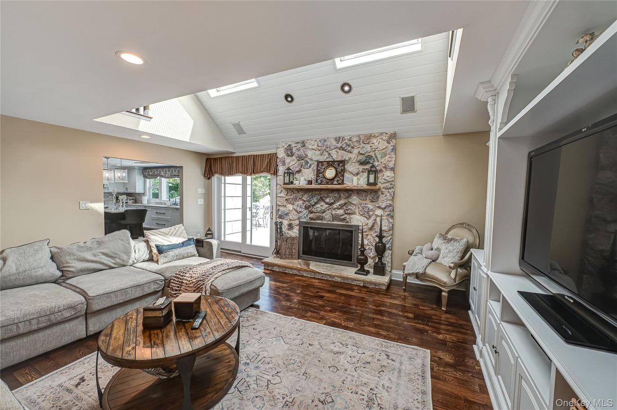 Fireplace, Interior, Living room, Recessed Lighting, Stone Walls, Wood Texture Flooring