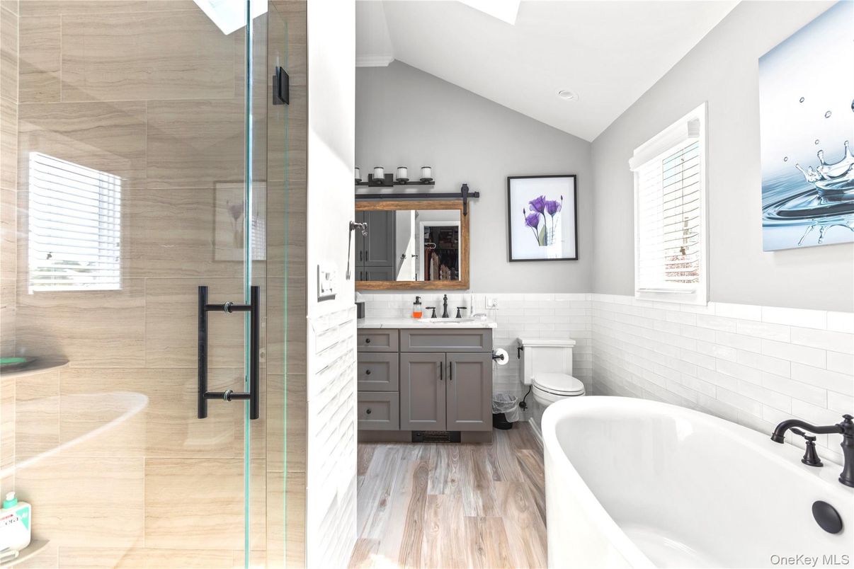 Bathroom, Free Standing Baths, Glass Shower, Interior, Recessed Lighting, Wood Texture Flooring