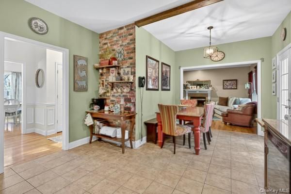 Chandelier, Dining room, Fireplace, Interior, Living room, Pendant Lights, Stone Walls, Wood Texture Flooring