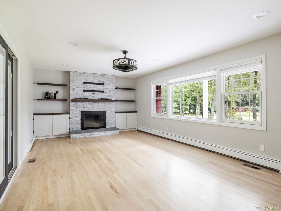 Empty room, Fireplace, Interior, Recessed Lighting, Stone Walls, Wood Texture Flooring
