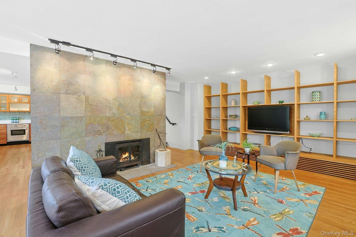 Fireplace, Interior, Living room, Recessed Lighting, Stone Walls, Wood Texture Flooring