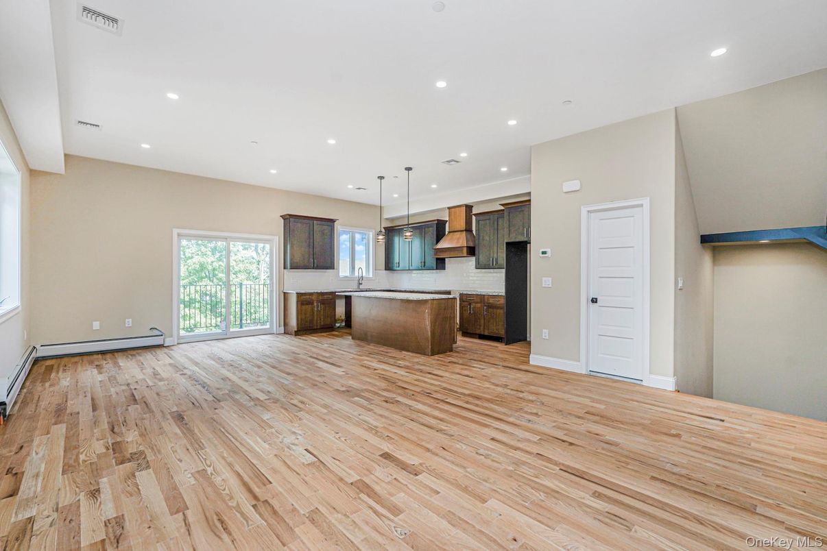 Empty room, Interior, Kitchen, Pendant Lights, Recessed Lighting, Stainless Steel Appliances, Wood Texture Flooring
