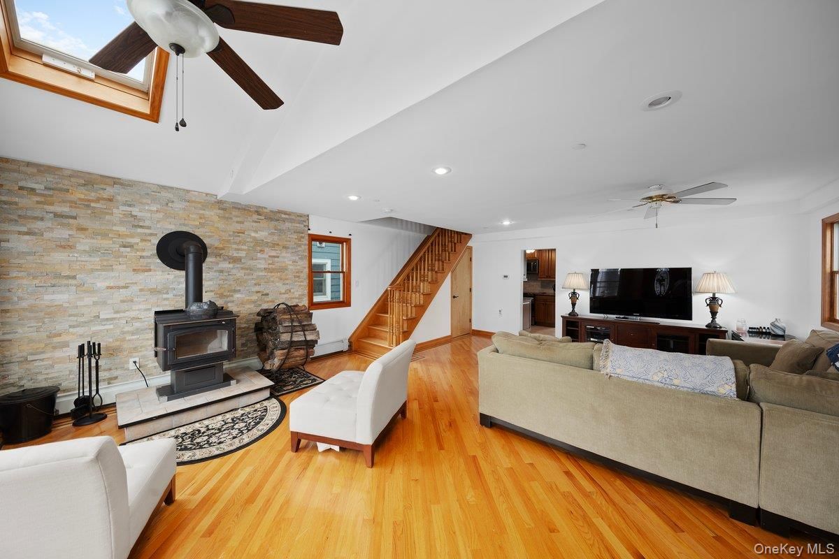 Fireplace, Interior, Living room, Recessed Lighting, Stone Walls, Wood Texture Flooring