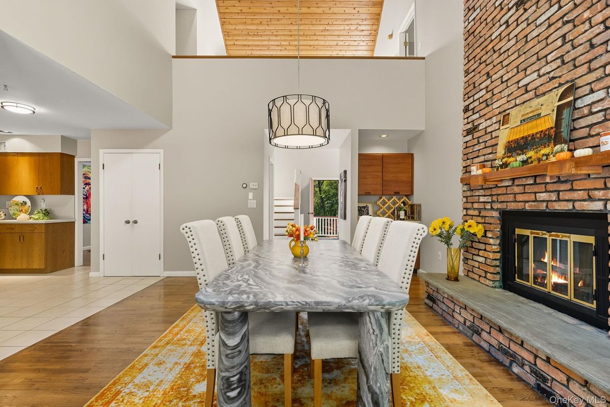 Dining room, Fireplace, Interior, Pendant Lights, Recessed Lighting, Stone Walls, Wood Texture Flooring