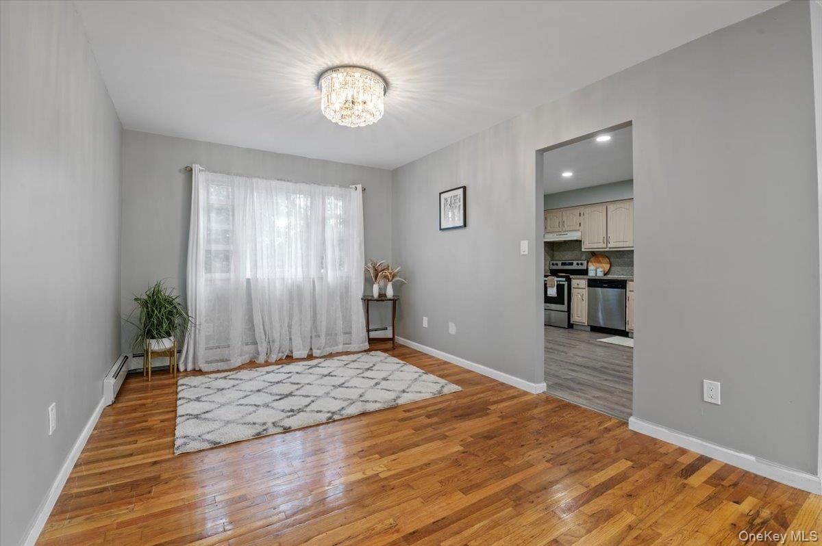 Chandelier, Empty room, Interior, Kitchen, Recessed Lighting, Stainless Steel Appliances, Wood Texture Flooring