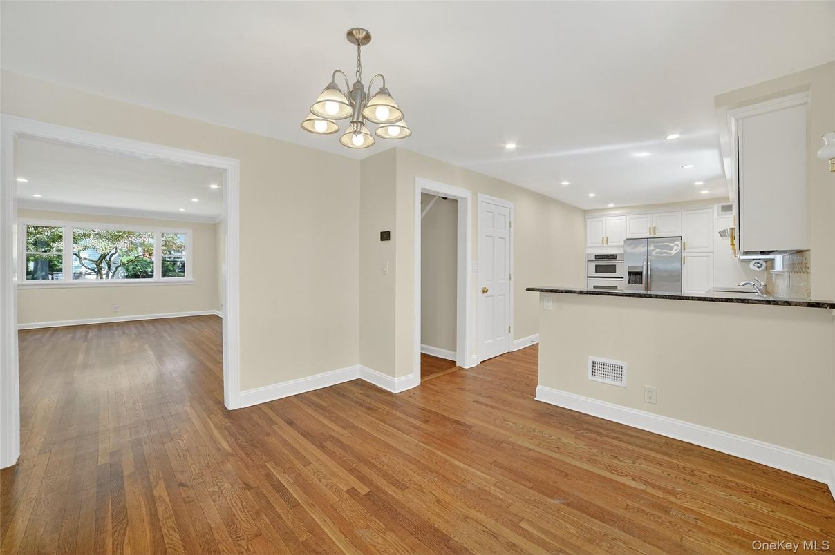Empty room, Interior, Kitchen, Recessed Lighting, Stainless Steel Appliances, Wood Texture Flooring