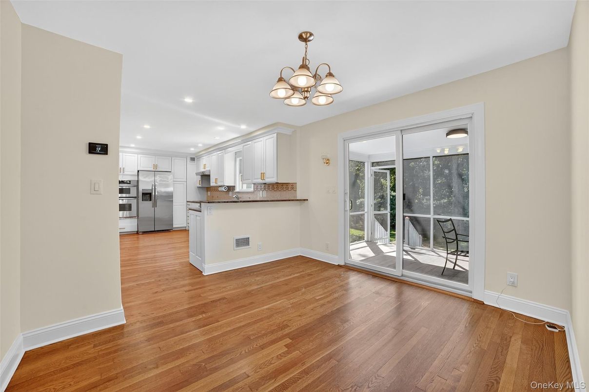 Empty room, Interior, Kitchen, Recessed Lighting, Stainless Steel Appliances, Wood Texture Flooring