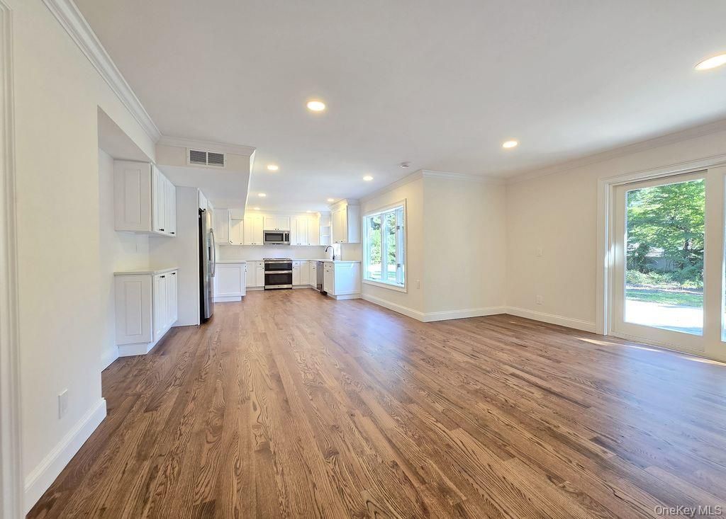 Empty room, Interior, Kitchen, Recessed Lighting, Stainless Steel Appliances, Wood Texture Flooring
