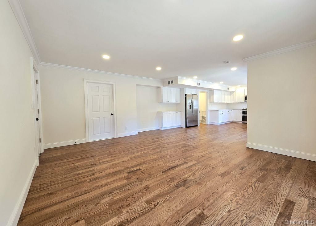 Empty room, Interior, Kitchen, Recessed Lighting, Stainless Steel Appliances, Wood Texture Flooring