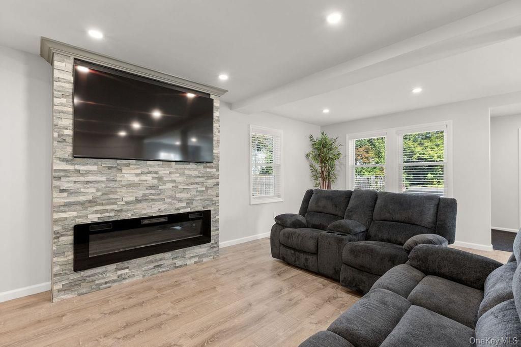 Fireplace, Interior, Living room, Recessed Lighting, Stone Walls, Wood Texture Flooring