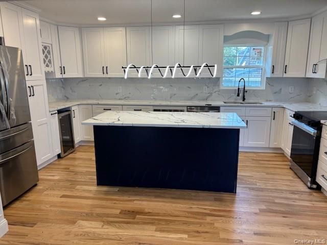 Interior, Kitchen, Marble Walls, Recessed Lighting, Stainless Steel Appliances, Wood Texture Flooring