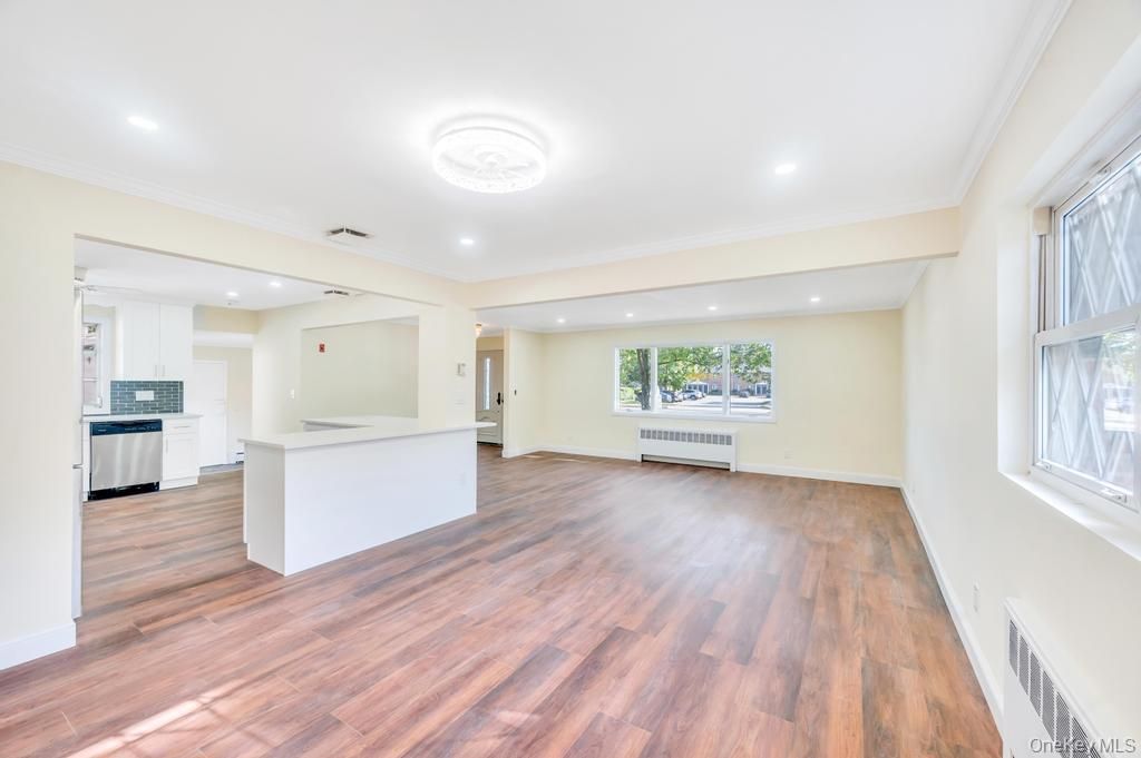Empty room, Interior, Kitchen, Recessed Lighting, Stainless Steel Appliances, Wood Texture Flooring