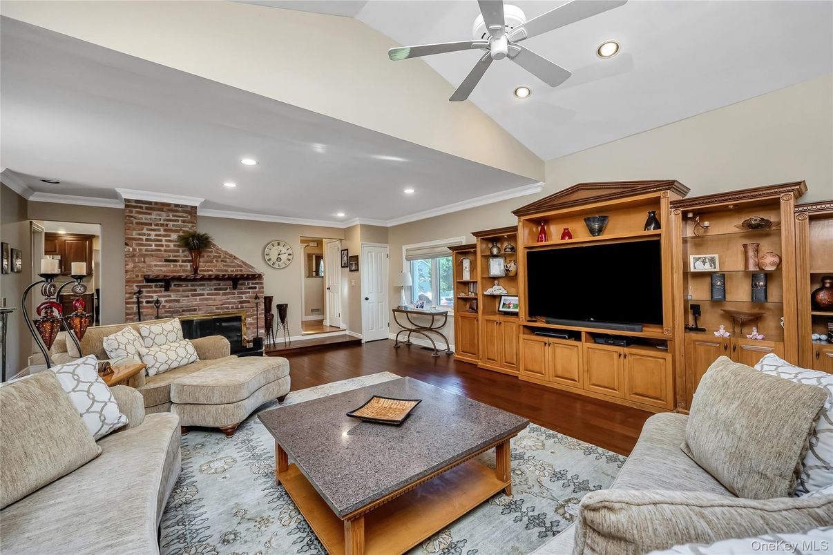 Fireplace, Interior, Living room, Recessed Lighting, Stone Walls, Wood Texture Flooring