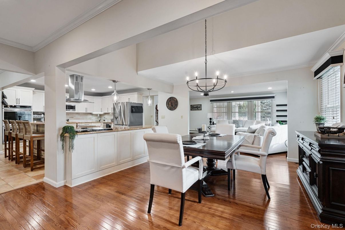 Chandelier, Dining room, Interior, Kitchen, Living room, Pendant Lights, Recessed Lighting, Stainless Steel Appliances, Wood Texture Flooring