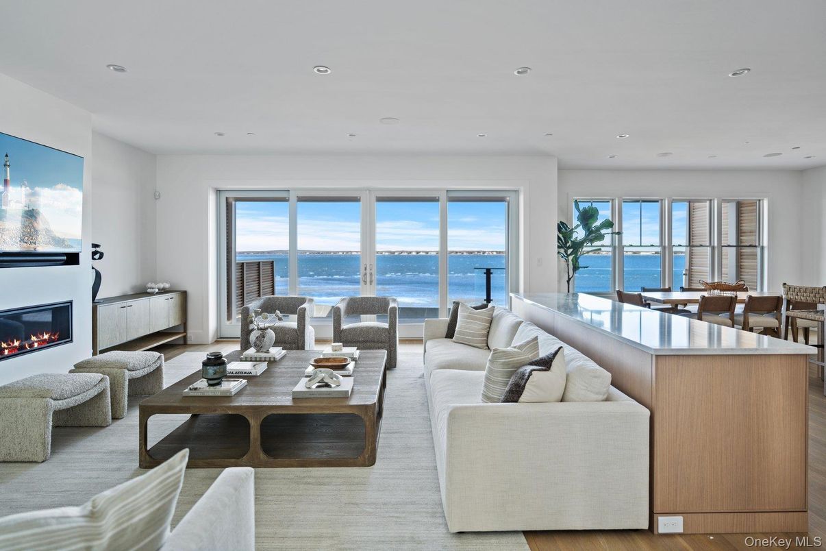 Dining room, Fireplace, Interior, Living room, Recessed Lighting, Water, Wood Texture Flooring