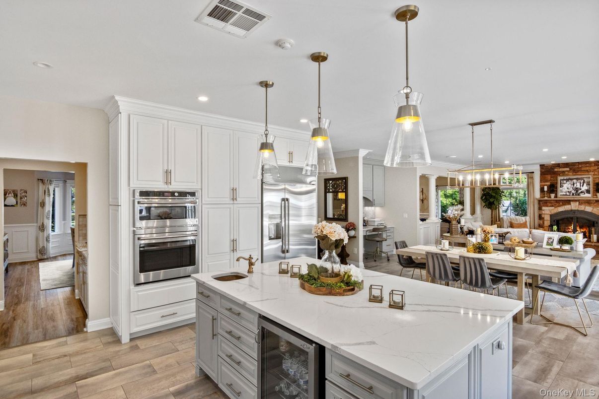 Dining room, Fireplace, Interior, Kitchen, Pendant Lights, Recessed Lighting, Stainless Steel Appliances, Wood Texture Flooring