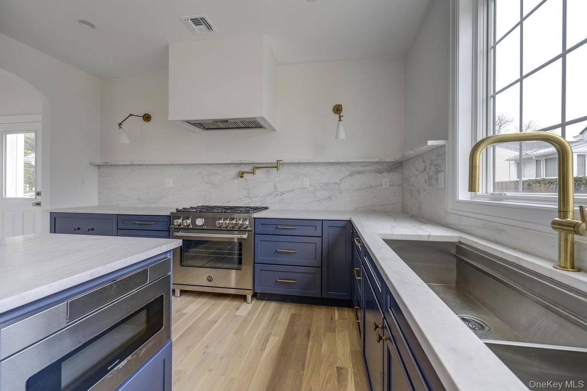 Interior, Kitchen, Marble Walls, Recessed Lighting, Stainless Steel Appliances, Wood Texture Flooring
