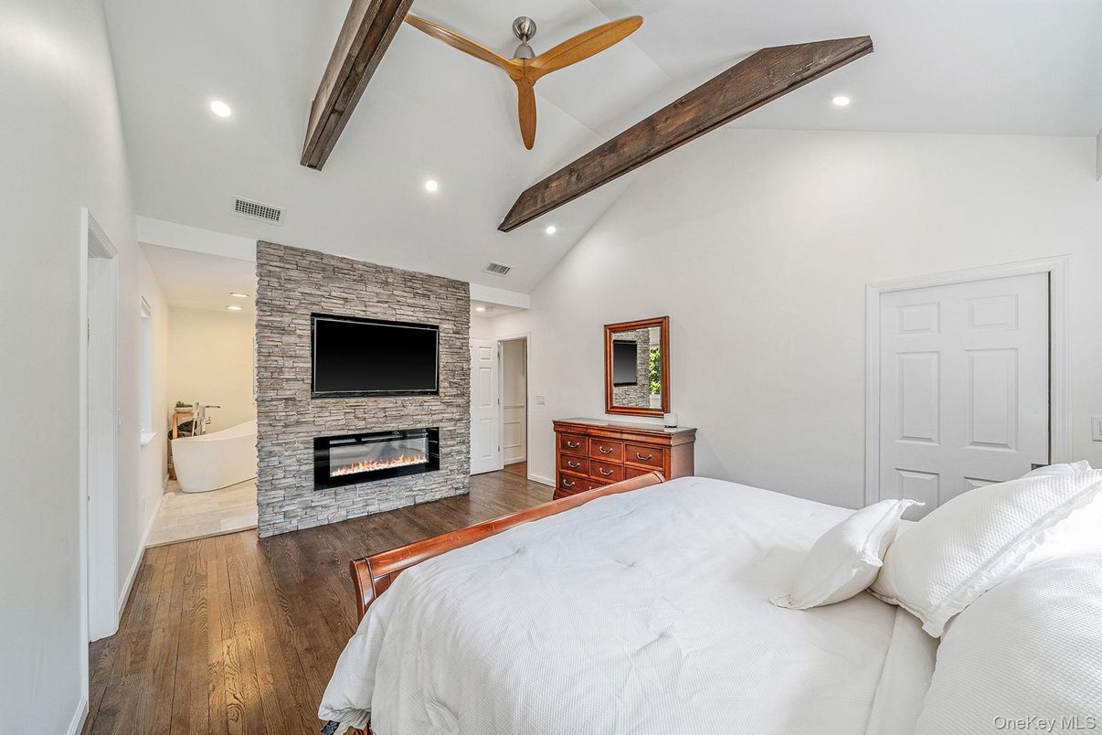 Bedroom, Fireplace, Interior, Recessed Lighting, Stone Walls, Wooden Beams, Wood Texture Flooring