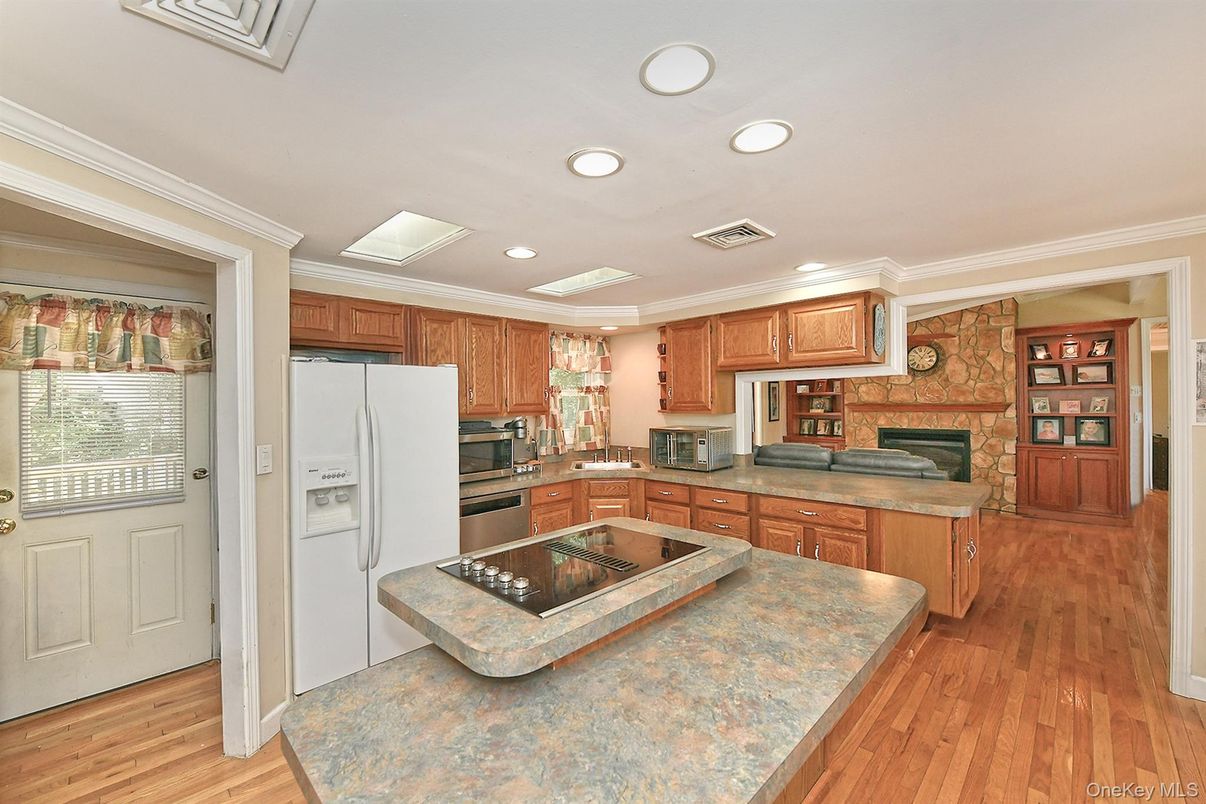 Fireplace, Interior, Kitchen, Recessed Lighting, Stone Walls, Wood Texture Flooring