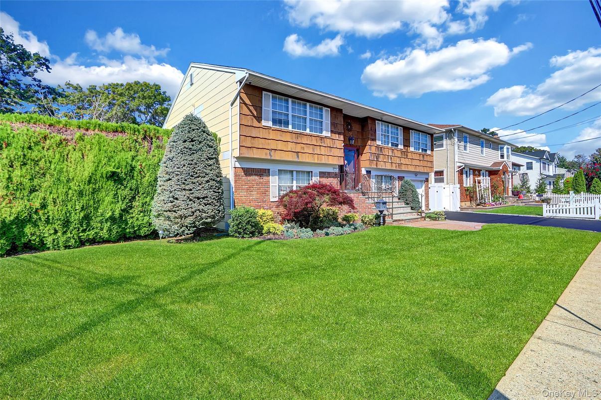 Attached, Backyard, Exterior, Facade, Brick Facade, Raised Ranch