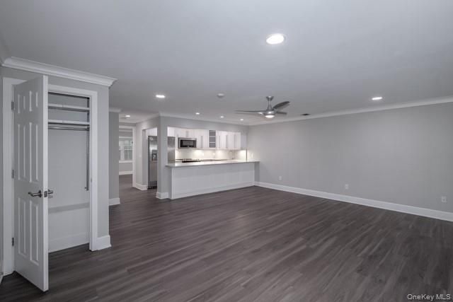 Empty room, Interior, Kitchen, Recessed Lighting, Stainless Steel Appliances, Wood Texture Flooring