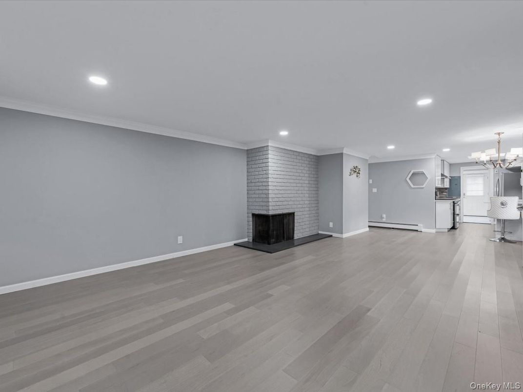 Chandelier, Empty room, Fireplace, Interior, Kitchen, Recessed Lighting, Wood Texture Flooring