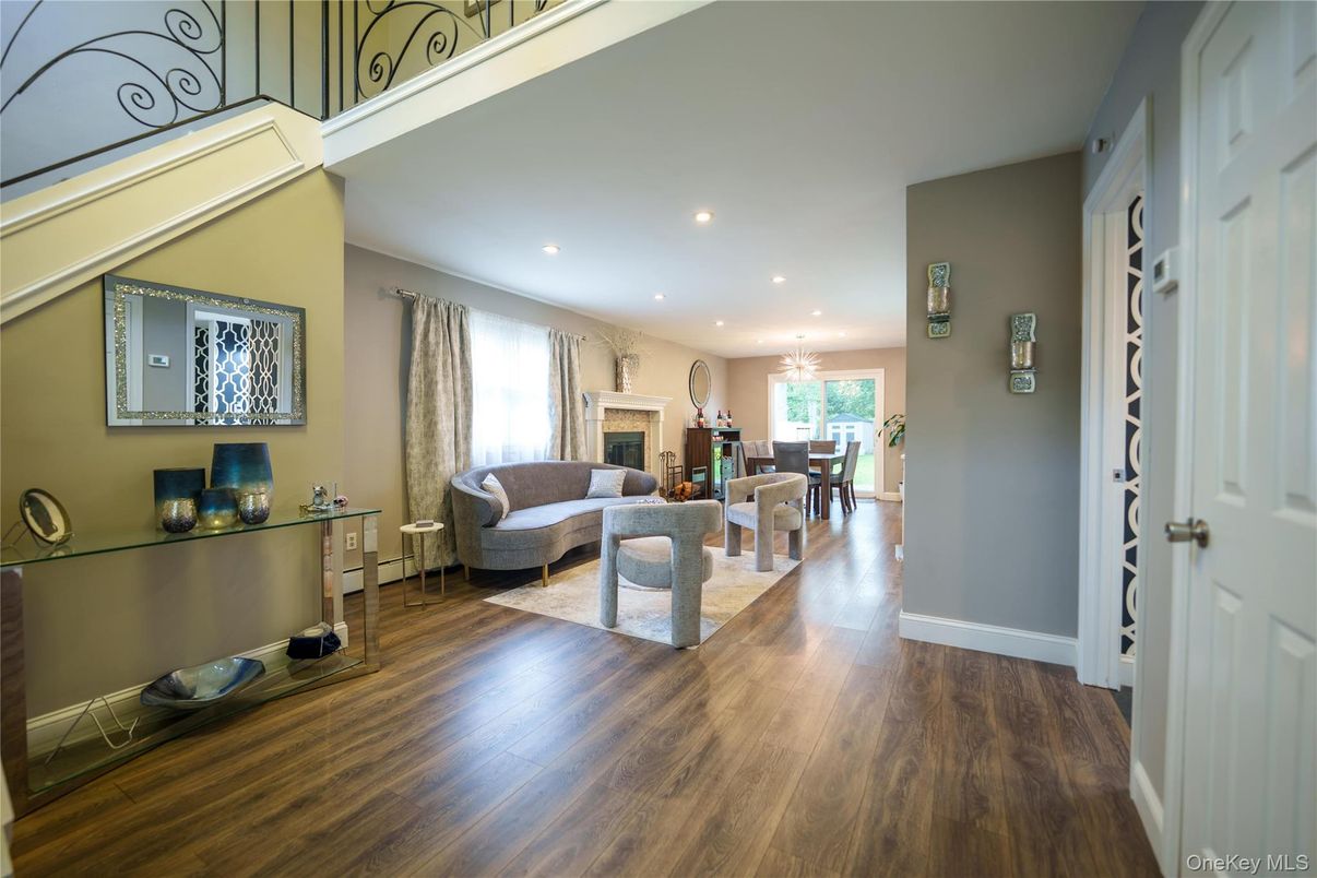 Dining room, Fireplace, Interior, Living room, Recessed Lighting, Wood Texture Flooring