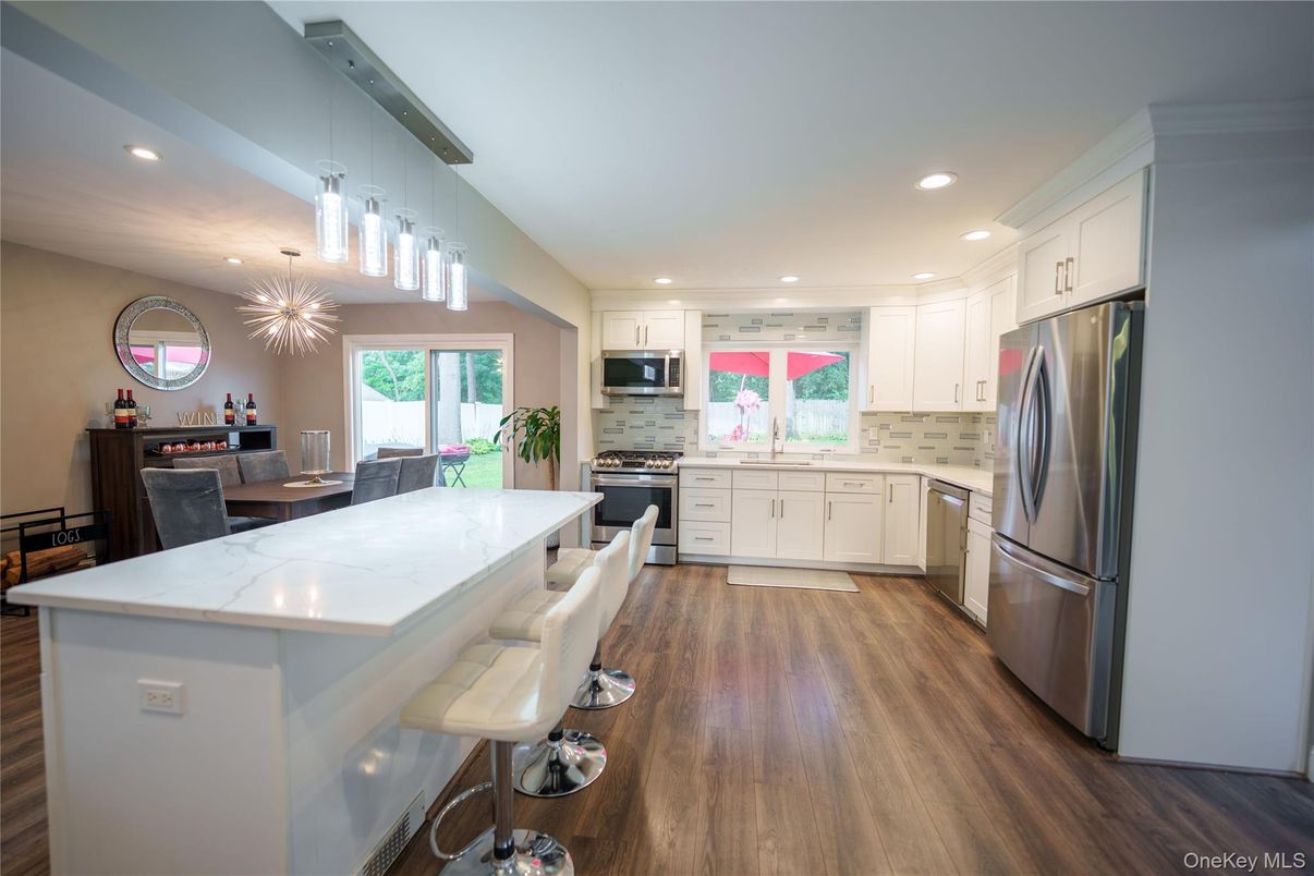 Dining room, Interior, Kitchen, Pendant Lights, Recessed Lighting, Stainless Steel Appliances, Wood Texture Flooring