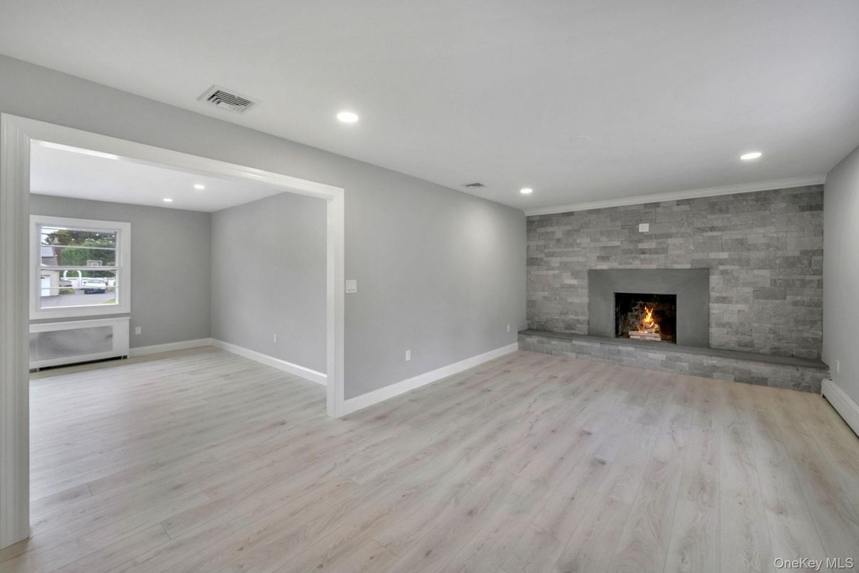 Empty room, Fireplace, Interior, Recessed Lighting, Stone Walls, Wood Texture Flooring